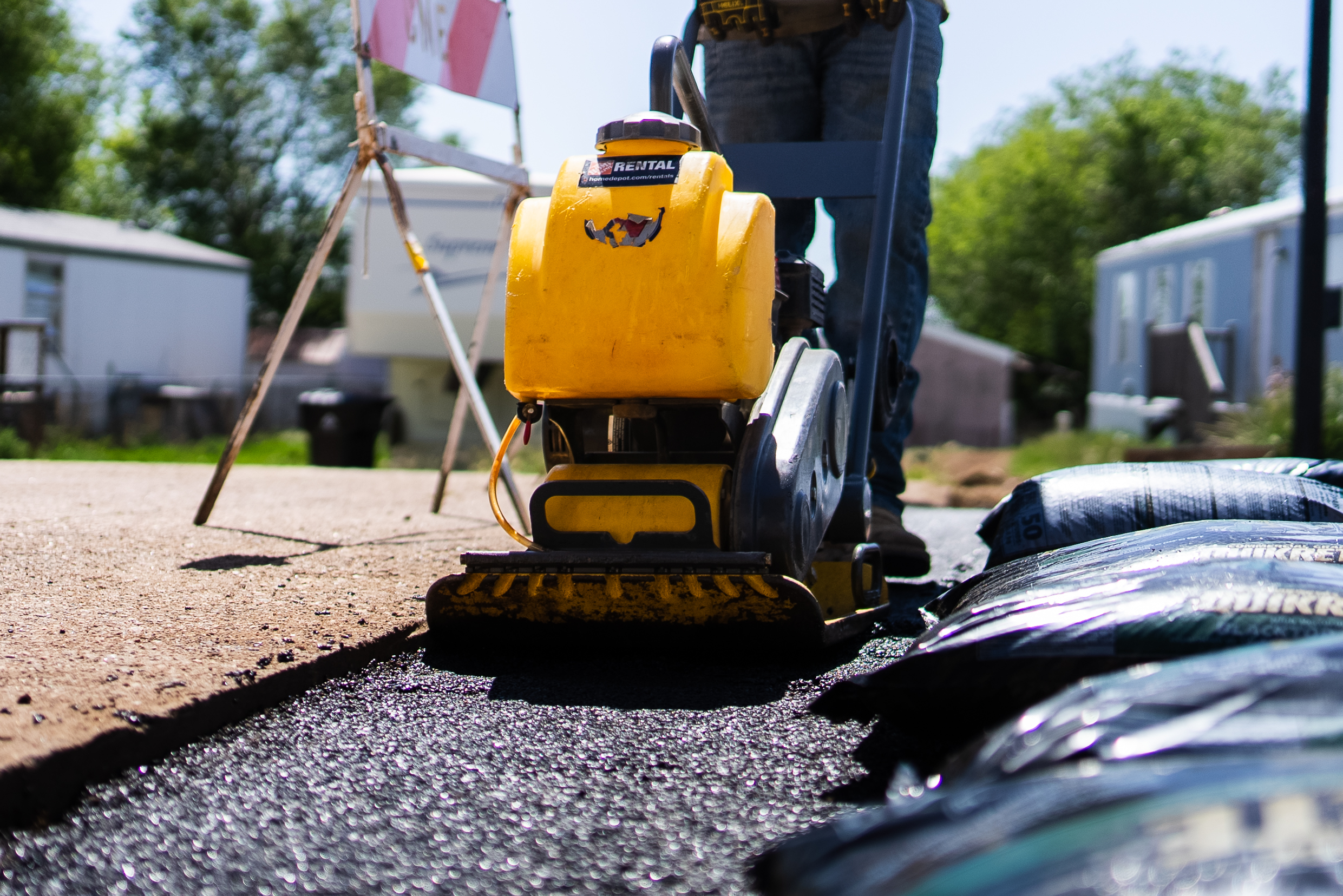 TrenchCore crew operating a plate compactor for surface restoration